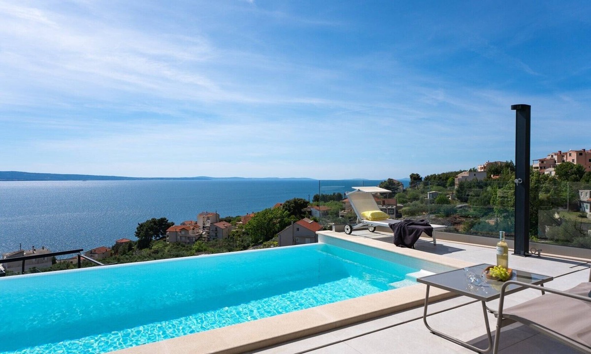 Jesenice Villa | Three-bedroom Villa Sunshine with a heated pool, media room, and views of the sea