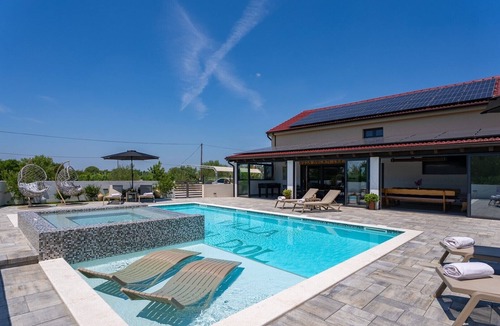 Oklaj Villa | 4 en-suite bedrooms, two finnish saunas, heated pool with Whirlpool, deck chairs in shallow area, natural surroundings