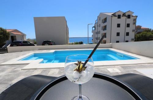Kolan Apartment | Dolphin view II with a pool by the beach