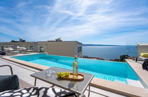 Jesenice Villa | Three-bedroom Villa Sunshine with a heated pool, media room, and views of the sea