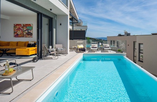 Jesenice Villa | Three-bedroom Villa Sunshine with a heated pool, media room, and views of the sea