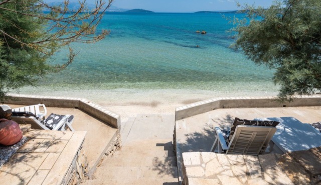 Beachfront villa Mihovil with direct beach access, garden, pool and mooring in Kastel Stafilic