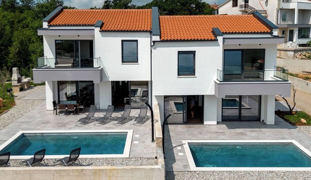 Beautiful villa with a pool, ocean view, and sandy beach by TRAVELER Tourist Agency Krk in Risika