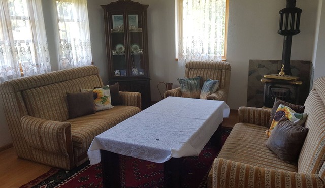 Bosnian house next to the Una river, with a view of the old Ostrovica fortress in Kulen Vakuf