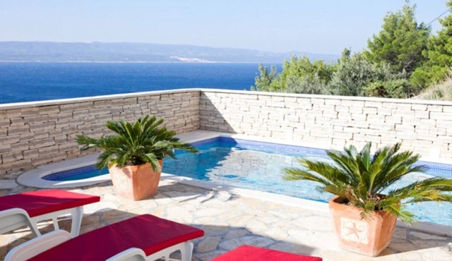 Modern vacation apartment with pool and sea view