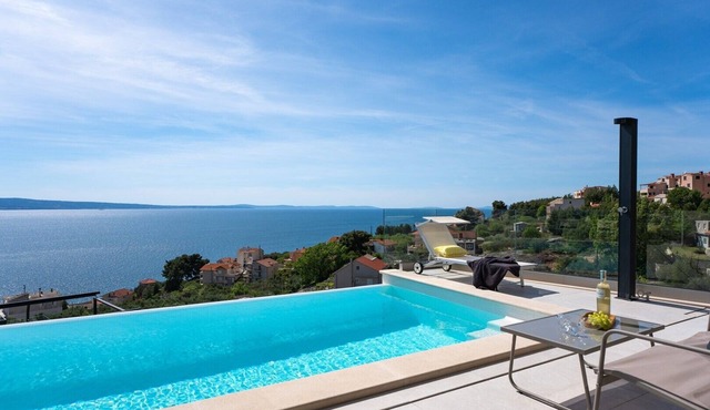 Three-bedroom Villa Sunshine with a heated pool, media room, and views of the sea